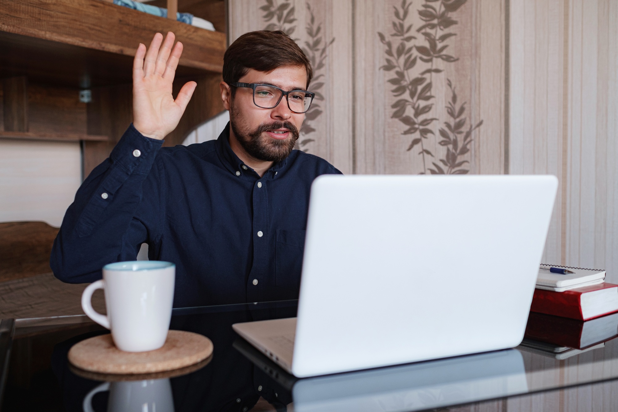 Focused man sitting at desk watching webinar video course